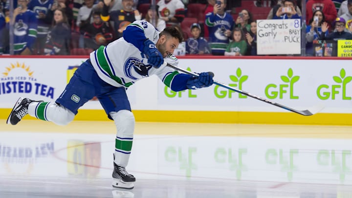 Nov 23, 2024; Ottawa, Ontario, CAN; Vancouver Canucks center Max Sasson (63) shoots the puck during warmup prior to game against the against the Ottawa Senators at the Canadian Tire Centre. Mandatory Credit: Marc DesRosiers-Imagn Images