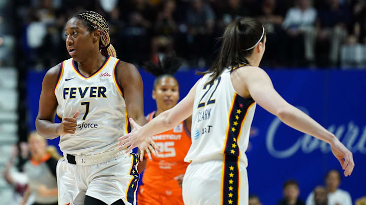 Jun 10, 2024; Uncasville, Connecticut, USA; Indiana Fever forward Aliyah Boston (7) and guard Caitlin Clark (22) react after a basket against the Connecticut Sun in the first quarter at Mohegan Sun Arena. Mandatory Credit: David Butler II-Imagn Images
