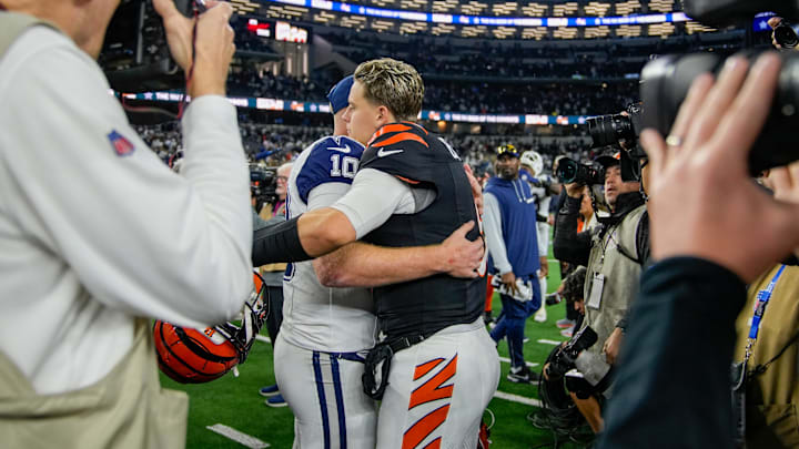 Cincinnati Bengals quarterback Joe Burrow (9) hugs Dallas Cowboys quarterback Cooper Rush (10) after the Bengals beat the Cowboys 27-20 in Monday Night Football at AT&T Stadium in Arlington,Texas on Monday, December 9, 2024.