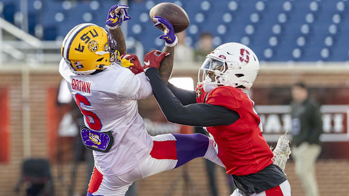 Jan 29, 2026; Mobile, AL, USA; American wide receiver Barion Brown (6) of LSU battle for a pass with American cornerback Collin Wright (6) of Stanford during American Senior Bowl practice at Hancock Whitney Stadium. Mandatory Credit: Vasha Hunt-Imagn Images
