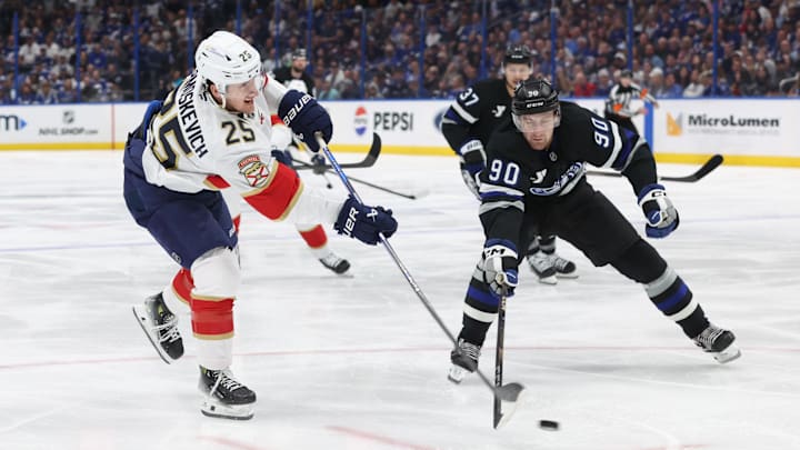 Florida Panthers right wing Mackie Samoskevich shoots as Tampa Bay Lightning defenseman J.J. Moser defends.