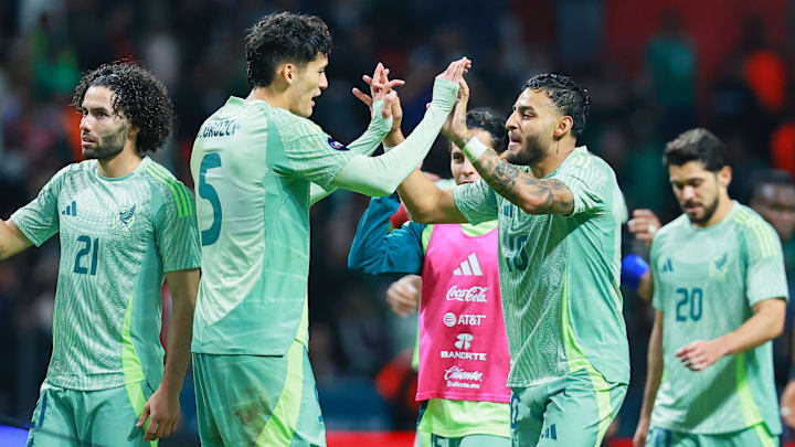 Chiquete Orozco celebra uno de los goles con Alexis Vega