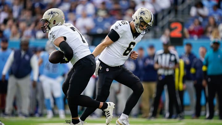 New Orleans Saints quarterback Tyler Shough (6) hands off to quarterback Taysom Hill (7) during the first quarter at Nissan Stadium in Nashville, Tenn., Sunday, Dec. 28, 2025.