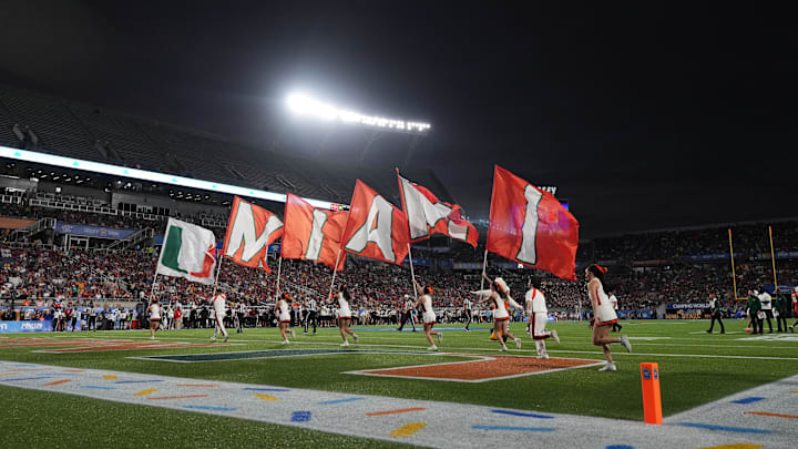 Miami Hurricanes cheerleaders run on the field with flags after a touchdown against the Iowa State Cyclones during the second half at Camping World Stadium. Miami Hurricanes cheerleaders run on the field with flags after a touchdown against the Iowa State Cyclones during the second half at Camping World Stadium.