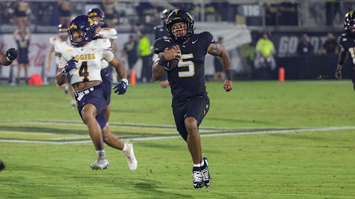 Sep 6, 2025; Orlando, Florida, USA; UCF Knights running back Jaden Nixon (5) runs a 96 yard kickoff return for a touchdown during the first quarter against the North Carolina A&T Aggies at Acrisure Bounce House. Mandatory Credit: Mike Watters-Imagn Images