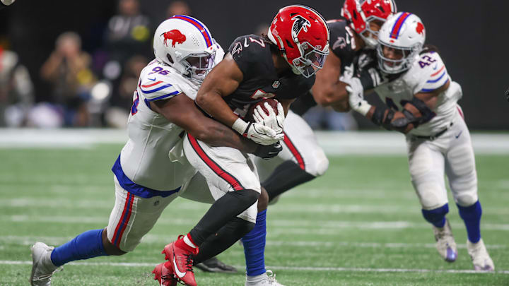 Atlanta Falcons running back Bijan Robinson is tackled by Buffalo Bills defensive tackle Deone Walker.