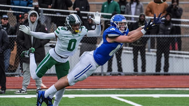 Novi Detroit Catholic Central‘s Jack Janda stretches out but fails to pull in the pass while being covered by Cass Tech’s Lamont Wilcoxson in the fourth quarter during the MHSAA semifinals of the state playoffs at Troy Athens High School on Saturday, Nov. 23, 2024.