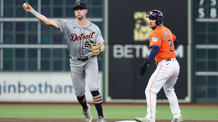 Oct 2, 2024; Houston, Texas, USA; Detroit Tigers shortstop Trey Sweeney (27) throws to first base to retire Houston Astros catcher Victor Caratini (not pictured) as Houston third baseman Alex Bregman (2) advances to second during the second inning of game two of the Wildcard round for the 2024 MLB Playoffs at Minute Maid Park.