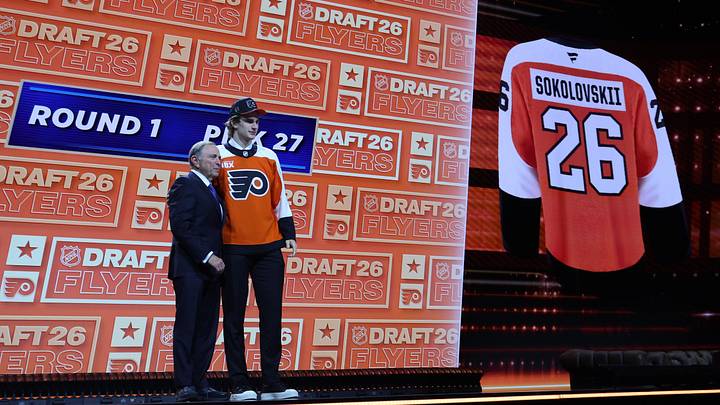 Jun 26, 2026; Buffalo, New York, USA; Maksim Sokolovskii reacts beside NHL commissioner Gary Bettman after being selected with the twenty seventh pick in the first round of the 2026 NHL Draft by the Philadelphia Flyers at KeyBank Center. Mandatory Credit: Timothy T. Ludwig-Imagn Images