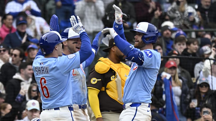 Apr 5, 2025; Chicago, Illinois, USA;  Chicago Cubs catcher Carson Kelly (15) high fives Matt Shaw (6) and second baseman Nico Hoerner (2)  after he hit a three run home run against the San Diego Padres during the sixth inning at Wrigley Field. 