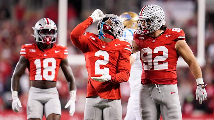 Ohio State Buckeyes defensive back Caleb Downs (2) celebrates a tackle with defensive end Caden Curry (92) and safety Jaylen McClain (18) during the NCAA football game against the UCLA Bruins at Ohio Stadium in Columbus on Nov. 15, 2025. Ohio State Buckeyes defensive back Caleb Downs (2) celebrates a tackle with defensive end Caden Curry (92) and safety Jaylen McClain (18) during the NCAA football game against the UCLA Bruins at Ohio Stadium in Columbus on Nov. 15, 2025.