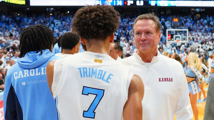 Nov 7, 2025; Chapel Hill, North Carolina, USA;  Kansas Jayhawks head coach Bill Self with North Carolina Tar Heels guard Seth Trimble (7) after the game at Dean E. Smith Center. Mandatory Credit: Bob Donnan-Imagn Images