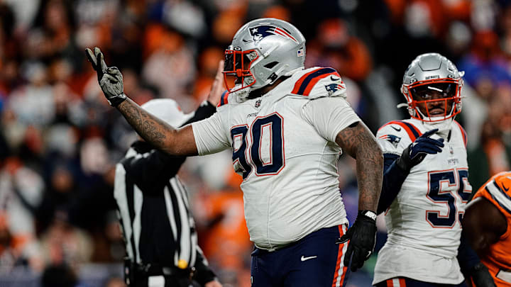 Dec 24, 2023; Denver, Colorado, USA; New England Patriots defensive tackle Christian Barmore (90) reacts after a play ]in the third quarter against the Denver Broncos at Empower Field at Mile High.