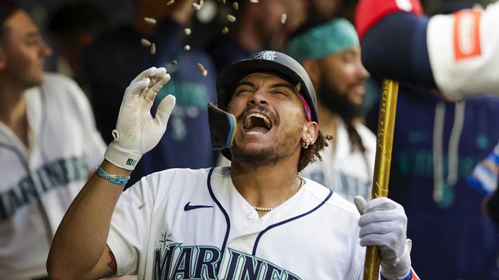 Jun 1, 2026; Seattle, Washington, USA; Seattle Mariners first baseman Josh Naylor (12) celebrates in the dugout after hitting a solo-home run against the New York Mets during the sixth inning at T-Mobile Park. Mandatory Credit: Joe Nicholson-Imagn Images
