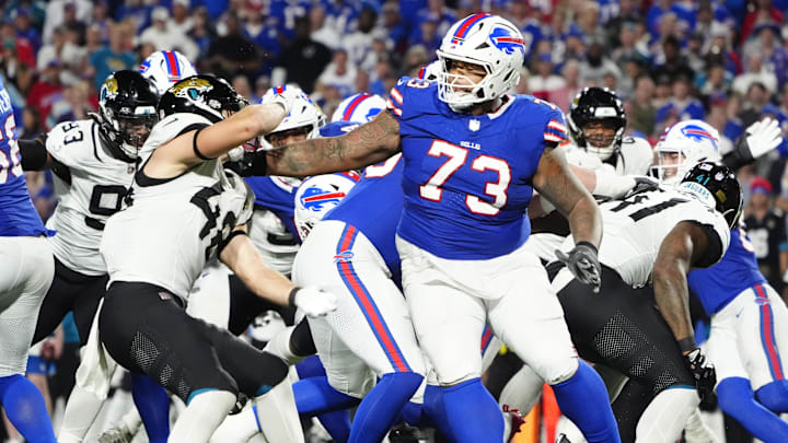 Sep 23, 2024; Orchard Park, New York, USA; Buffalo Bills offensive tackle Dion Dawkins (73) blocks Jacksonville Jaguars linebacker Chad Muma (48) during the second half at Highmark Stadium. 