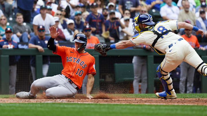 Jul 20, 2025; Seattle, Washington, USA; Houston Astros third baseman Shay Whitcomb (10) slides home to score a run against Seattle Mariners catcher Mitch Garver (18) during the fifth inning at T-Mobile Park. 