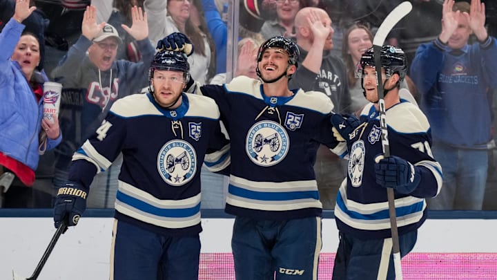 Feb 28, 2026; Columbus, Ohio, USA;  Columbus Blue Jackets left wing Mason Marchment, middle, celebrates with teammates after scoring a goal against the New York Islanders in the second period at Nationwide Arena. Mandatory Credit: Aaron Doster-Imagn Images