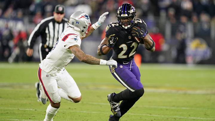 Dec 21, 2025; Baltimore, Maryland, USA; Baltimore Ravens running back Derrick Henry (22) runs the ball against New England Patriots cornerback Christian Gonzalez (0) during the second half of the game at M&T Bank Stadium. Mandatory Credit: Mitch Stringer-Imagn Images Dec 21, 2025; Baltimore, Maryland, USA; Baltimore Ravens running back Derrick Henry (22) runs the ball against New England Patriots cornerback Christian Gonzalez (0) during the second half of the game at M&T Bank Stadium. Mandatory Credit: Mitch Stringer-Imagn Images