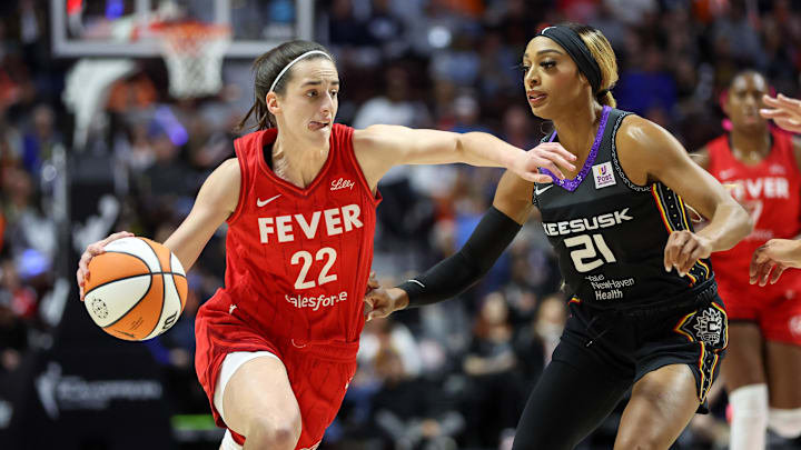 Clark drives to the basket defended by Connecticut Sun guard DiJonai Carrington during the first half during game two of the first round of the 2024 WNBA Playoffs.