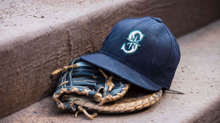 Aug 18, 2015; Arlington, TX, USA; A view of a Seattle Mariners ball cap and glove during the game between the Texas Rangers and the Seattle Mariners at Globe Life Park in Arlington. The Mariners defeat the Rangers 3-2. Mandatory Credit: Jerome Miron-Imagn Images Aug 18, 2015; Arlington, TX, USA; A view of a Seattle Mariners ball cap and glove during the game between the Texas Rangers and the Seattle Mariners at Globe Life Park in Arlington. The Mariners defeat the Rangers 3-2. Mandatory Credit: Jerome Miron-Imagn Images