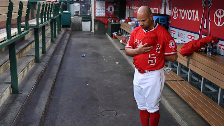 Los Angeles Angels first baseman Albert Pujols in the dugout during the national anthem before the start of a game against the Texas Rangers at Angel Stadium of Anaheim on Apr 5, 2019. Los Angeles Angels first baseman Albert Pujols in the dugout during the national anthem before the start of a game against the Texas Rangers at Angel Stadium of Anaheim on Apr 5, 2019.