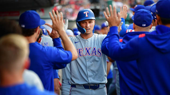 Texas Rangers shortstop Corey Seager (5) is greeted after hitting a two-run home run.