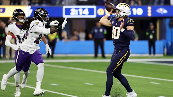 Los Angeles Chargers quarterback Justin Herbert (10) passes the ball as Baltimore Ravens linebacker Jadeveon Clowney (24) rushes during the first quarter at SoFi Stadium. Los Angeles Chargers quarterback Justin Herbert (10) passes the ball as Baltimore Ravens linebacker Jadeveon Clowney (24) rushes during the first quarter at SoFi Stadium.