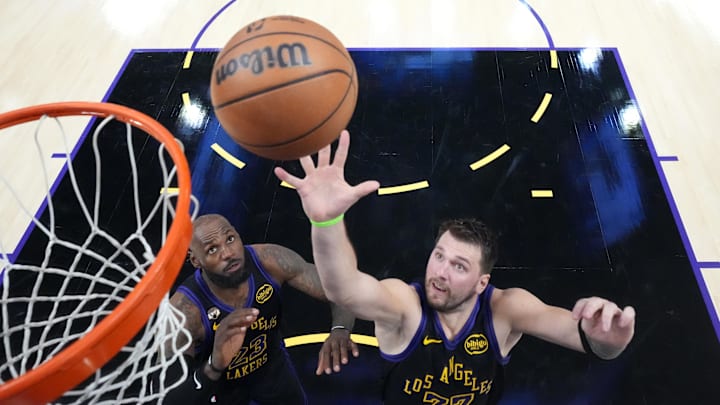 Mar 3, 2026; Los Angeles, California, USA; Los Angeles Lakers guard Luka Doncic (77) and forward LeBron James (23) rebound the ball against the New Orleans Pelicans in the second half at Crypto.com Arena. Mandatory Credit: Kirby Lee-Imagn Images
