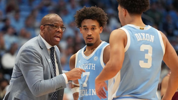 Dec 30, 2025; Chapel Hill, North Carolina, USA; North Carolina Tar Heels head coach Hubert Davis with guard Seth Trimble (7) and guard Derek Dixon (3) in the second half at Dean E. Smith Center. Mandatory Credit: Bob Donnan-Imagn Images