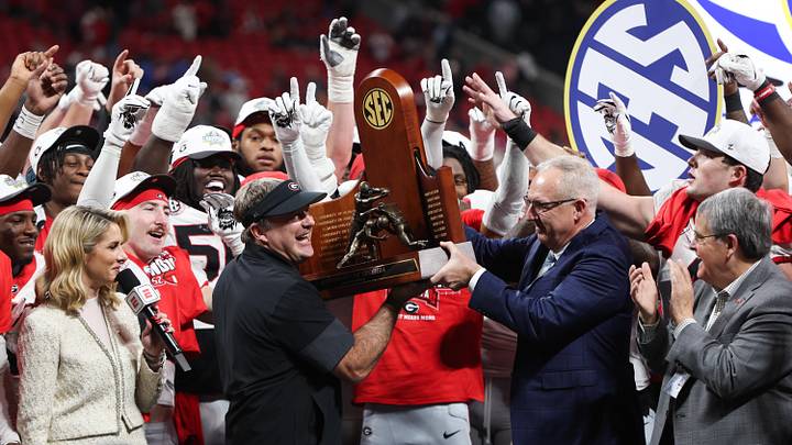 Dec 6, 2025; Atlanta, GA, USA; Georgia Bulldogs head coach Kirby Smart lifts the SEC Championship trophy after the game against the Alabama Crimson Tide during the 2025 SEC Championship game at Mercedes-Benz Stadium. Mandatory Credit: Brett Davis-Imagn Images Dec 6, 2025; Atlanta, GA, USA; Georgia Bulldogs head coach Kirby Smart lifts the SEC Championship trophy after the game against the Alabama Crimson Tide during the 2025 SEC Championship game at Mercedes-Benz Stadium. Mandatory Credit: Brett Davis-Imagn Images