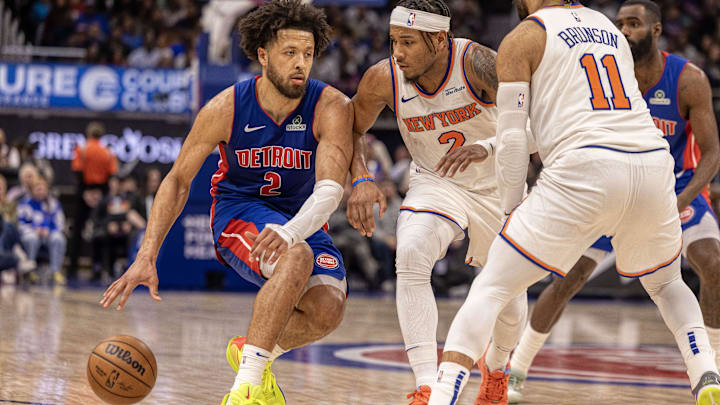 Apr 10, 2025; Detroit, Michigan, USA; Detroit Pistons guard Cade Cunningham (2) controls the ball next to New York Knicks guard Miles McBride (2) during the second half at Little Caesars Arena. Mandatory Credit: David Reginek-Imagn Images
