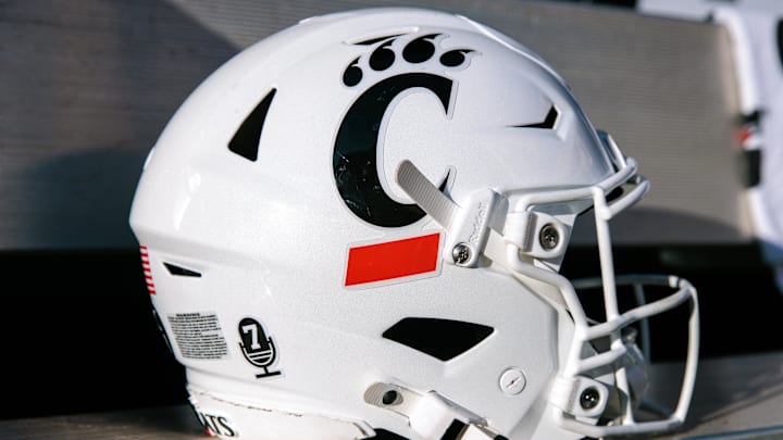 Oct 18, 2025; Stillwater, Oklahoma, USA; Cincinnati Bearcats helmet sits on the bench prior to the game against the Oklahoma State Cowboys at Boone Pickens Stadium. Mandatory Credit: William Purnell-Imagn Images