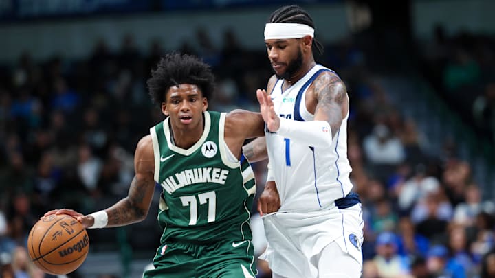 Oct 17, 2024; Dallas, Texas, USA;  Milwaukee Bucks guard AJ Johnson (77) dribbles as Dallas Mavericks guard Jaden Hardy (1) defends during the second half at American Airlines Center. Mandatory Credit: Kevin Jairaj-Imagn Images