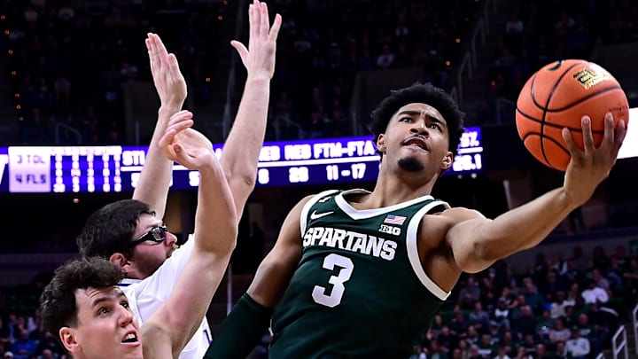 Jan 9, 2025; East Lansing, Michigan, USA; Michigan State Spartans guard Jaden Akins (3) puts in a shot in the paint against the Washington Huskies during the second half at Jack Breslin Student Events Center. Mandatory Credit: Dale Young-Imagn Images Jan 9, 2025; East Lansing, Michigan, USA; Michigan State Spartans guard Jaden Akins (3) puts in a shot in the paint against the Washington Huskies during the second half at Jack Breslin Student Events Center. Mandatory Credit: Dale Young-Imagn Images