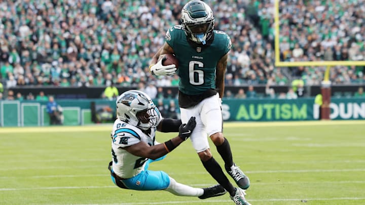 PHILADELPHIA, PENNSYLVANIA - DECEMBER 08: DeVonta Smith #6 of the Philadelphia Eagles carries the ball against Xavier Woods #25 of the Carolina Panthers during a game at Lincoln Financial Field on December 08, 2024 in Philadelphia, Pennsylvania. 