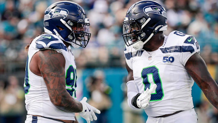Oct 12, 2025; Jacksonville, Florida, USA;Seattle Seahawks defensive end Leonard Williams (99) and linebacker DeMarcus Lawrence (0) celebrate after a play against the Jacksonville Jaguars at EverBank Stadium. 
