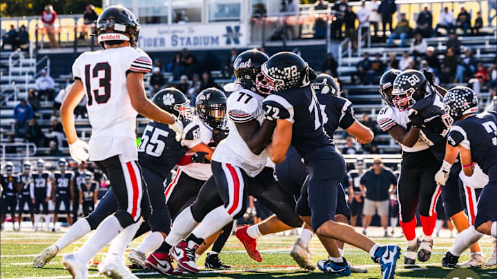 Offensive lineman Trevon Cole-Jenkins (77) makes a block for the Half Hollow Hills East varsity football team last season. Offensive lineman Trevon Cole-Jenkins (77) makes a block for the Half Hollow Hills East varsity football team last season.