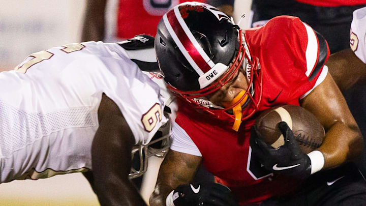 North Marion Colts Treyven Matthews (6) tackles Dunnellon Tigers Sean Martin (4). The Dunnellon Tigers hosted the North Marion Colts at Dunnellon High School in Dunnellon, FL on Monday, October 14, 2024. [Doug Engle/Ocala Star Banner]