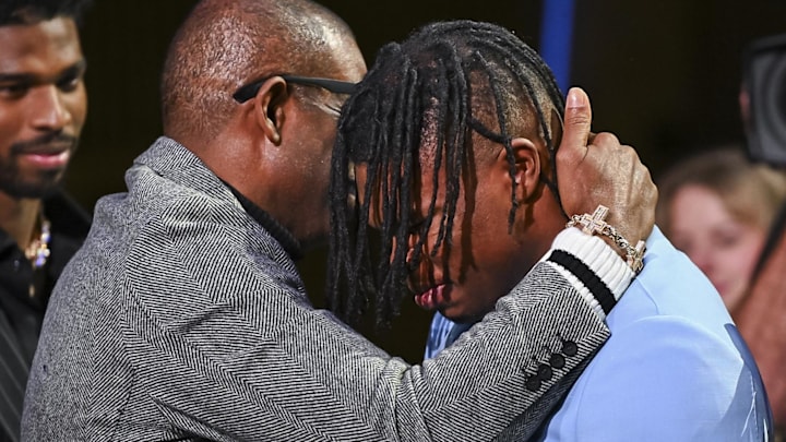 Colorado Buffaloes wide receiver/cornerback Travis Hunter with head coach Deion Sanders after winning the 2024 Heisman Trophy. 