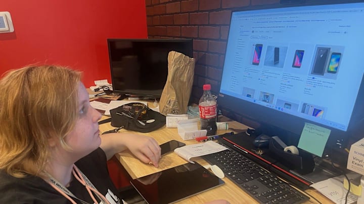 Lister Cody Spencer works on getting a used iPad listed on eBay for sale