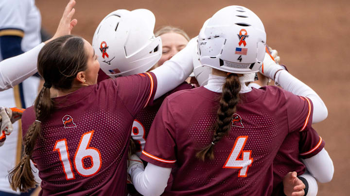 Jordan Lynch (16) and Michelle Chatfield (4) join a swarm of Hokies in a celebration. Jordan Lynch (16) and Michelle Chatfield (4) join a swarm of Hokies in a celebration.