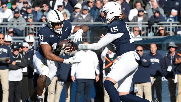 Penn State Nittany Lions quarterback Drew Allar hands off to running back Nicholas Singleton during a Big Ten Conference football game at Beaver Stadium.