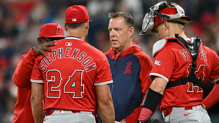 May 30, 2025; Cleveland, Ohio, USA; Los Angeles Angels relief pitcher Robert Stephenson (24) is looked at by a trainer after being injured during the seventh inning against the Cleveland Guardians at Progressive Field. May 30, 2025; Cleveland, Ohio, USA; Los Angeles Angels relief pitcher Robert Stephenson (24) is looked at by a trainer after being injured during the seventh inning against the Cleveland Guardians at Progressive Field.