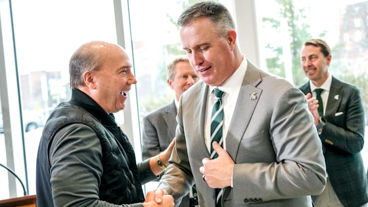 Greg Williams, left, shakes hands with Michigan State's new football coach Pat Fitzgerald during an introductory press conference on Tuesday, Dec. 2, 2025, at the Tom Izzo Football Building in East Lansing. Greg Williams, left, shakes hands with Michigan State's new football coach Pat Fitzgerald during an introductory press conference on Tuesday, Dec. 2, 2025, at the Tom Izzo Football Building in East Lansing.