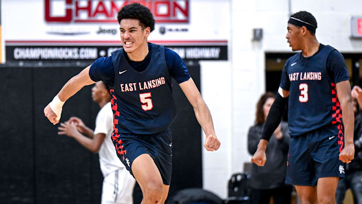 East Lansing's Cameron Hutson celebrates after his dunk against Waverly during the fourth quarter on Thursday, Dec. 19, 2024, at Waverly High School.