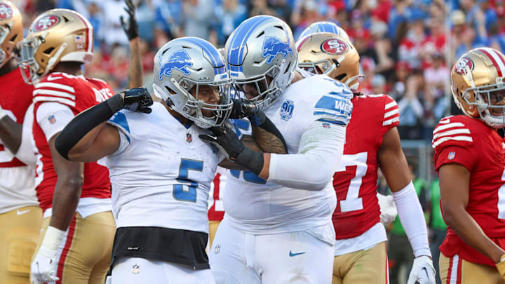 Lions running back David Montgomery, left, and offensive tackle Penei Sewell celebrate a touchdown