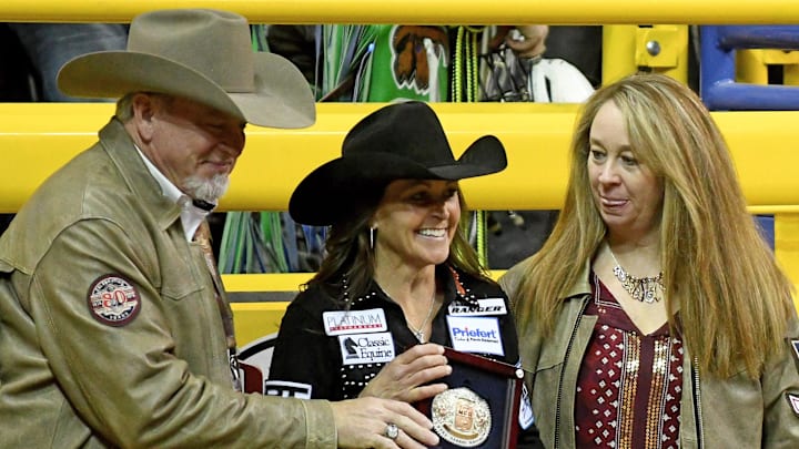 Dec 10, 2016; Las Vegas, NV, USA;  Barrel racer Lisa Lockhart receives a buckle for achieving the top overall average score on the final night of the National Finals Rodeo at Thomas & Mack Center. 