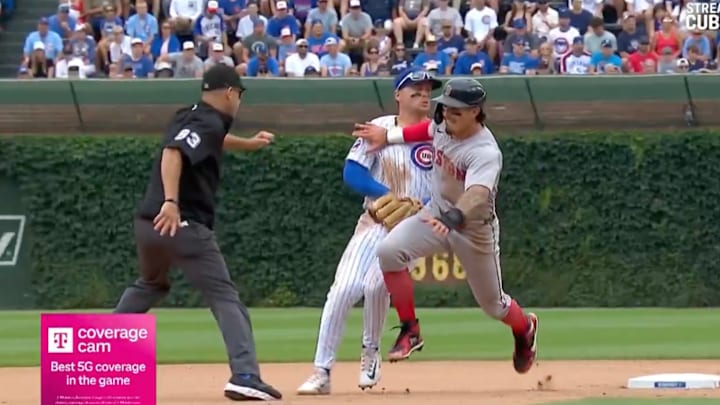 Jarren Duran tries to avoid multiple bodies while running the bases against the Chicago Cubs.