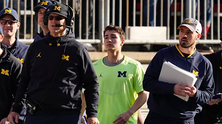 Nov 26, 2022; Columbus, Ohio, USA; Michigan Wolverines head coach Jim Harbaugh watches from the sideline beside off-field analyst Connor Stalions, right, during the NCAA football game against the Ohio State Buckeyes at Ohio Stadium.