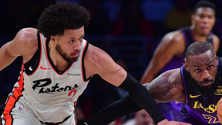 Dec 23, 2024; Los Angeles, California, USA; Los Angeles Lakers forward LeBron James (23) plays for the ball against Detroit Pistons guard Cade Cunningham (2) during the first half at Crypto.com Arena. Mandatory Credit: Gary A. Vasquez-Imagn Images